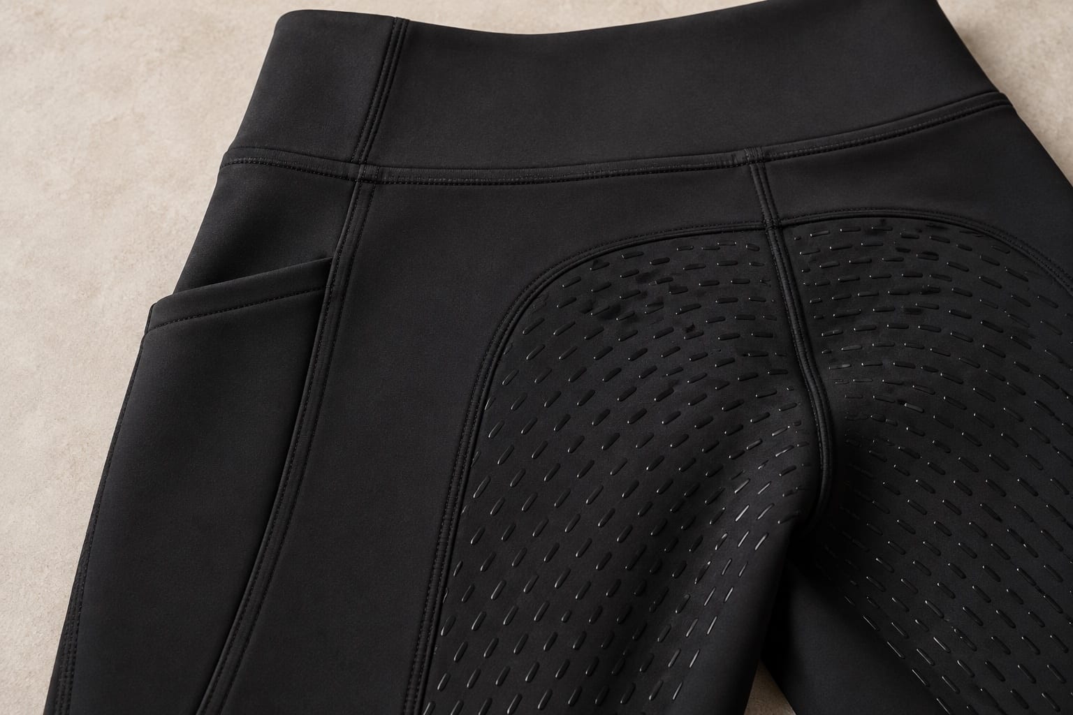 Riding tights & base layers detail showing a material application concept