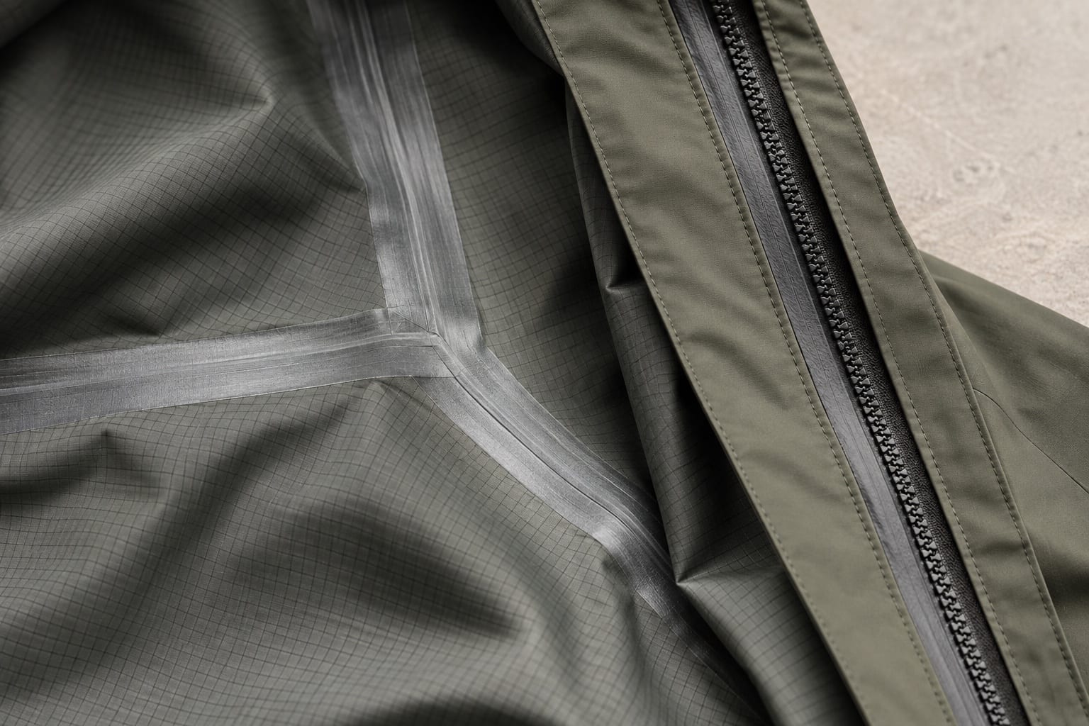 Lightweight rain riding shell construction and material close-up concept