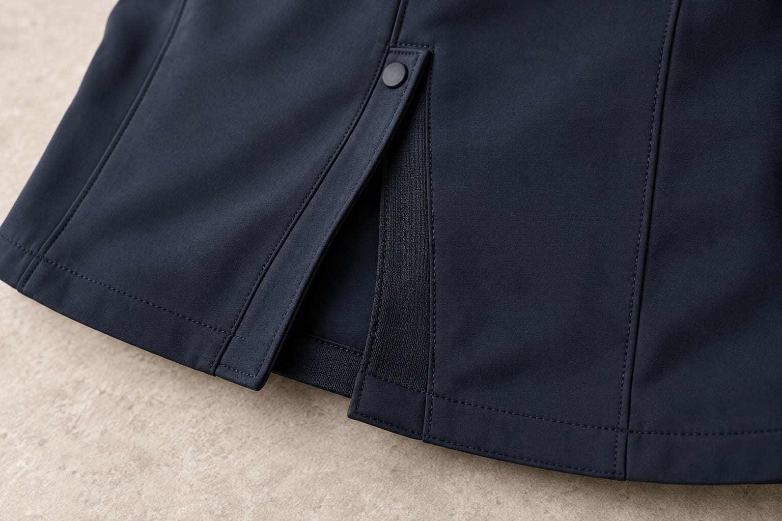 Stretch softshell riding jacket construction and material close-up concept
